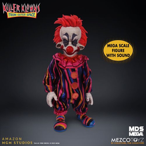 Colorful clown figure with red hair and striped outfit on a dark background, featuring Mezco Toyz branding.