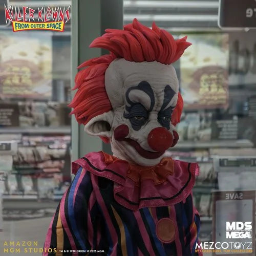 Clown figure with red hair and white face in a store setting, featuring 'Killer Klowns from Outer Space' branding.