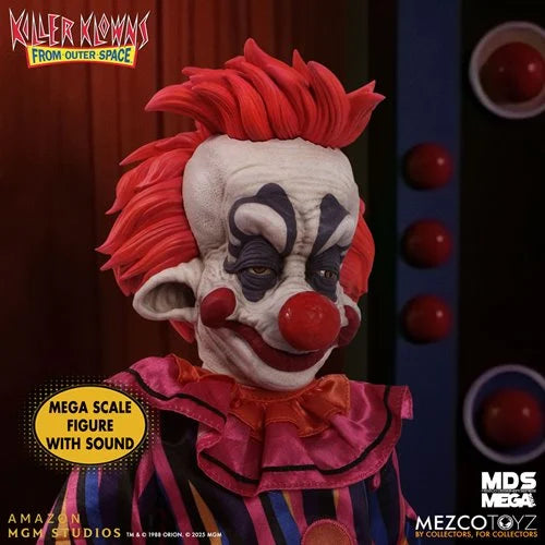 Mega scale collectible figure of the Killer Clown from Outer Space by Mezco Toyz, featuring detailed red hair, a creepy clown mask with a red nose and smile, and a striped purple and orange costume.
