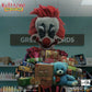 Clown figure holding boxes and a teddy bear with 'Killer Klowns from Outer Space' branding.
