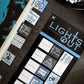 Set of book tabs with various designs and text on a dark surface