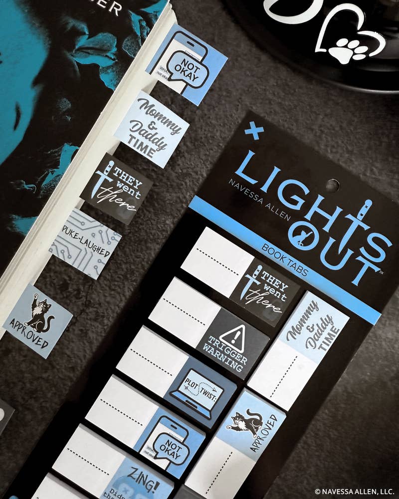 Set of book tabs with various designs and text on a dark surface