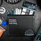 Black pouch with text and branding on a dark surface with various items.
