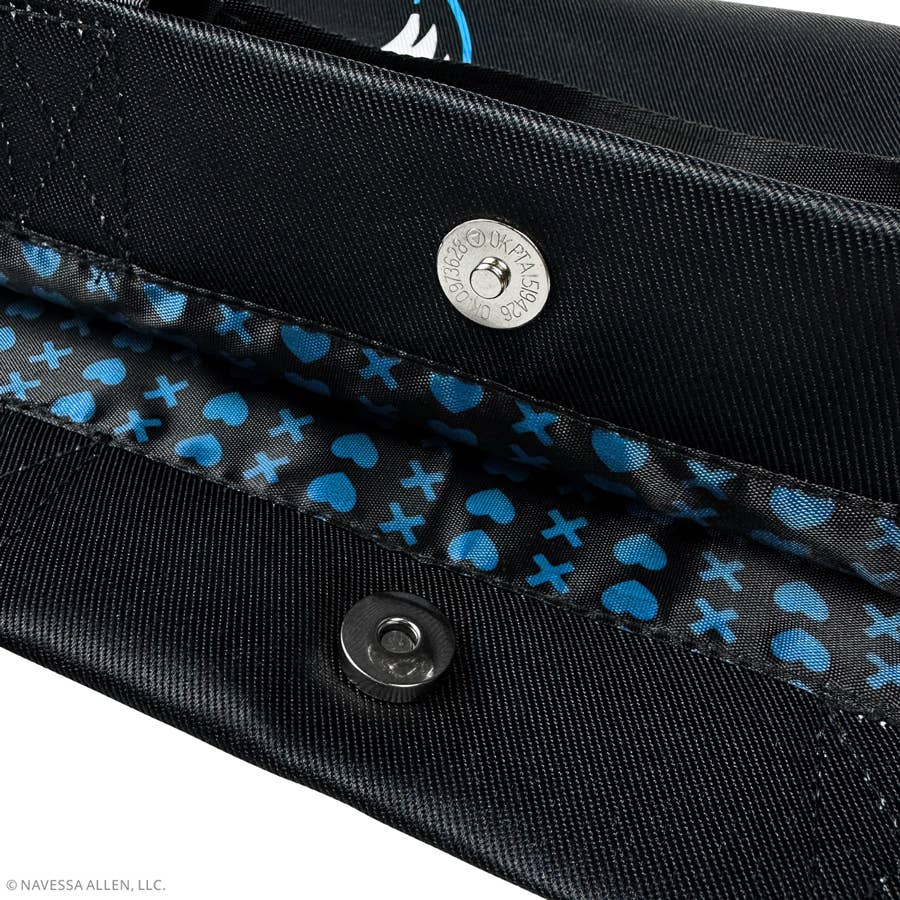 Close-up of a black bag with blue heart pattern and visible brand logo.