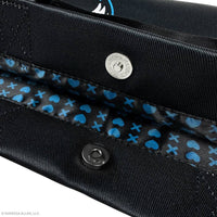 Close-up of a black bag with blue heart pattern and visible brand logo.