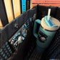 Blue tumbler with straw in a bag, featuring Balacлавa branding.