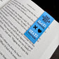 Blue bookmark with text and symbols on a book page