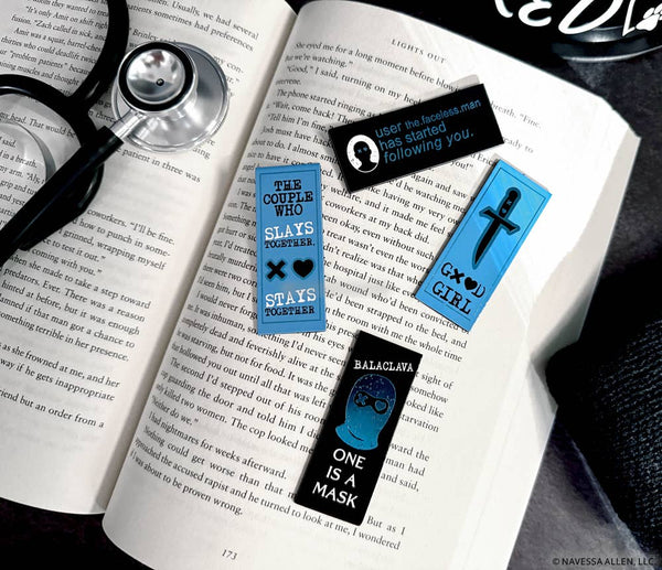 Open book with bookmarks featuring text and symbols on a dark surface
