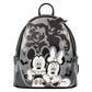 A Disney Minnie Mouse and Mickey Mouse backpack with a gray and black camouflage pattern, featuring black-and-white cartoon characters and spooky silhouettes on a white background.
