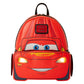 A red Disney Pixar Lightning McQueen backpack shaped like the character's car face, with blue eyes, a smiling mouth, and glowing yellow headlights, shown on a plain white background.