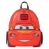 A red Lightning McQueen backpack shaped like his car face, featuring blue eyes, a smile, and a small Disney logo patch on the front, set against a plain white background.