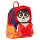 A Day of the Dead themed mini backpack featuring a large sugar skull graphic on the front, a red hooded design, a purple patterned upper section, and a yellow floral marigold pattern on the side pocket.