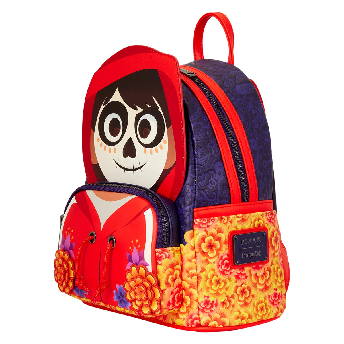 A Disney Pixar Coco themed backpack featuring a large Miguel character face on the front pocket, a red hood, a dark purple patterned upper section, and a yellow and orange floral patterned base, shown on a plain white background.