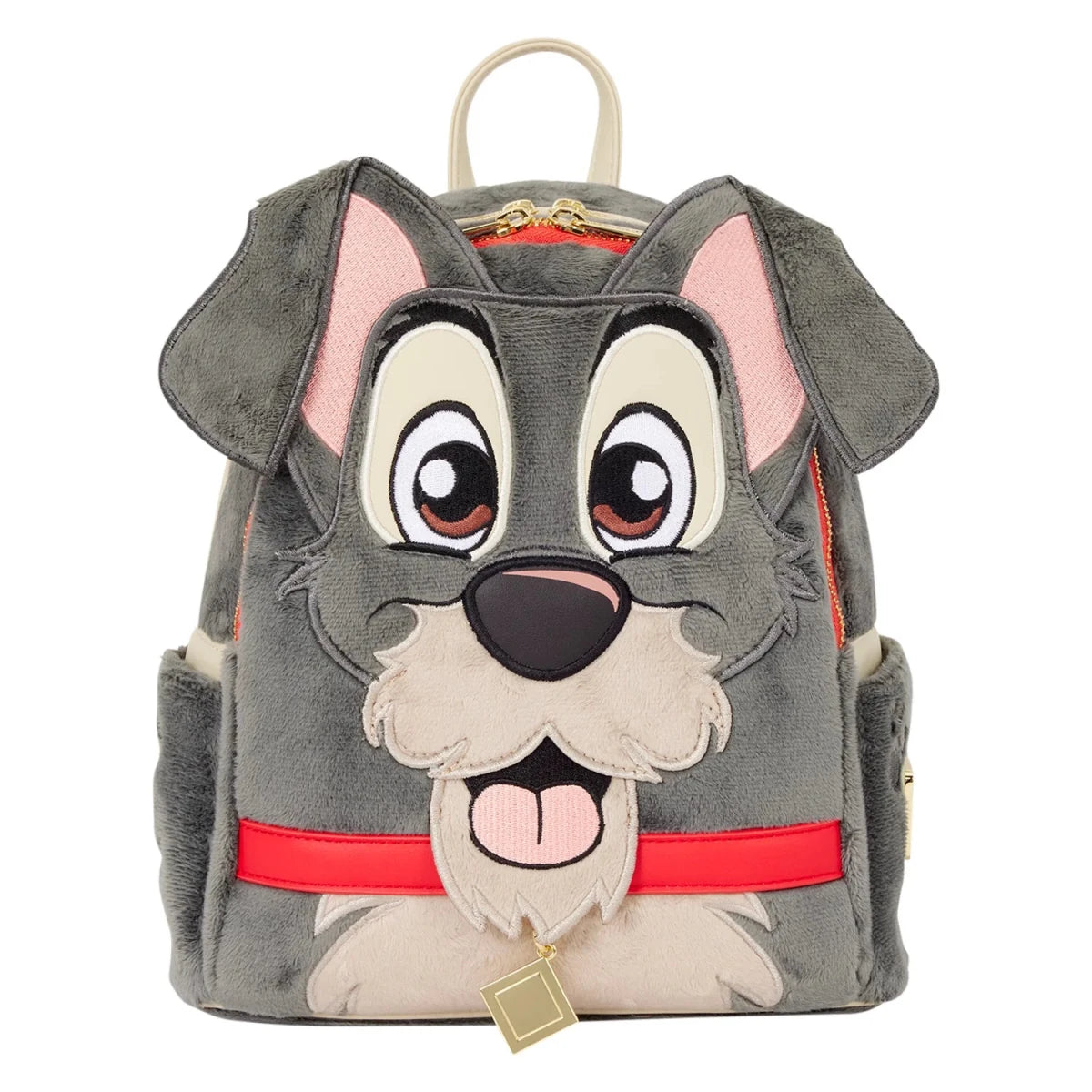 A plush dog-face backpack featuring gray and cream fur details, pink inner ears and tongue, a red collar, and a hanging gold charm, shown on a plain white background.