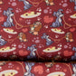A close-up of patterned fabric featuring cartoon dogs, hearts, and pizza slices on a dark red background.