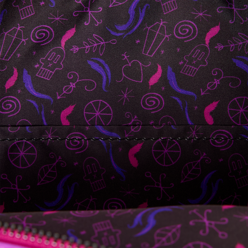 Close-up of a black fabric surface with a repeating pattern of pink and purple whimsical doodles and symbols, including a ghost, swirl, and abstract shapes. A stitched seam runs horizontally across the center, and part of a bright pink zipper is visible along the bottom edge.