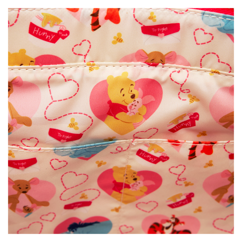 A Loungefly bag with Winnie the Pooh and his friends in a heart-themed pattern, crafted to transition seamlessly from a backpack to a tote.