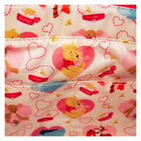 A Loungefly bag with Winnie the Pooh and his friends in a heart-themed pattern, crafted to transition seamlessly from a backpack to a tote.