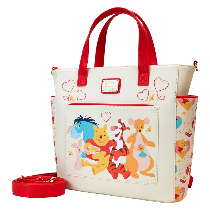 A delightful Loungefly Disney bag highlighting Winnie the Pooh, Piglet, Eeyore, and Tigger against a background of hearts, offering versatile carry options.

