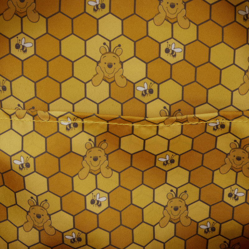 Fabric with honeycomb pattern featuring cartoon bears and bees.