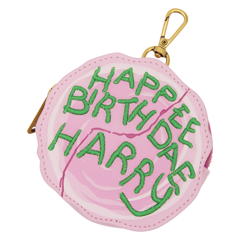 A round pink faux leather coin purse with a gold clasp, featuring green embroidered text that reads 'HAPPY BIRTH DAY HARRY' on a white background.