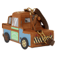A small car-shaped crossbody bag designed like the character Tow Mater from Toy Story, featuring a brown body, blue side panel, green sign, and gold-tone hardware, shown on a plain white background.
