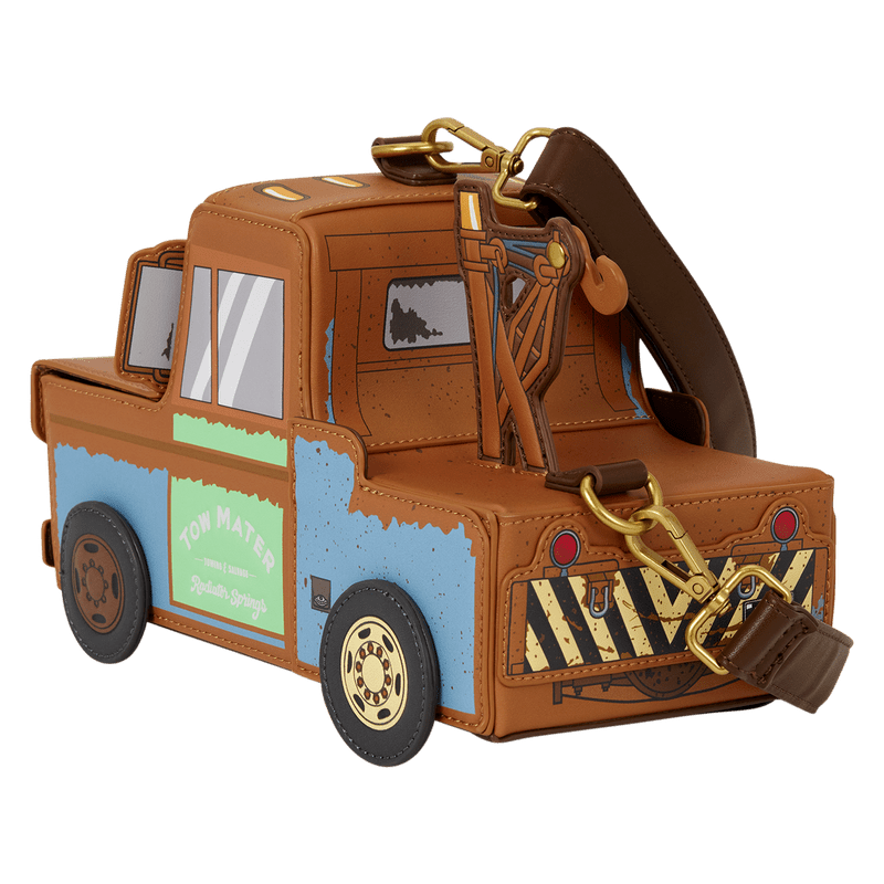 A small car-shaped crossbody bag designed like the character Tow Mater from Toy Story, featuring a brown body, blue side panel, green sign, and gold-tone hardware, shown on a plain white background.