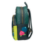 A dark green and black backpack with gold zippers, featuring an embossed fruit pattern on the top section and applique patches of a pink strawberry and a blue blueberry on the front pocket.