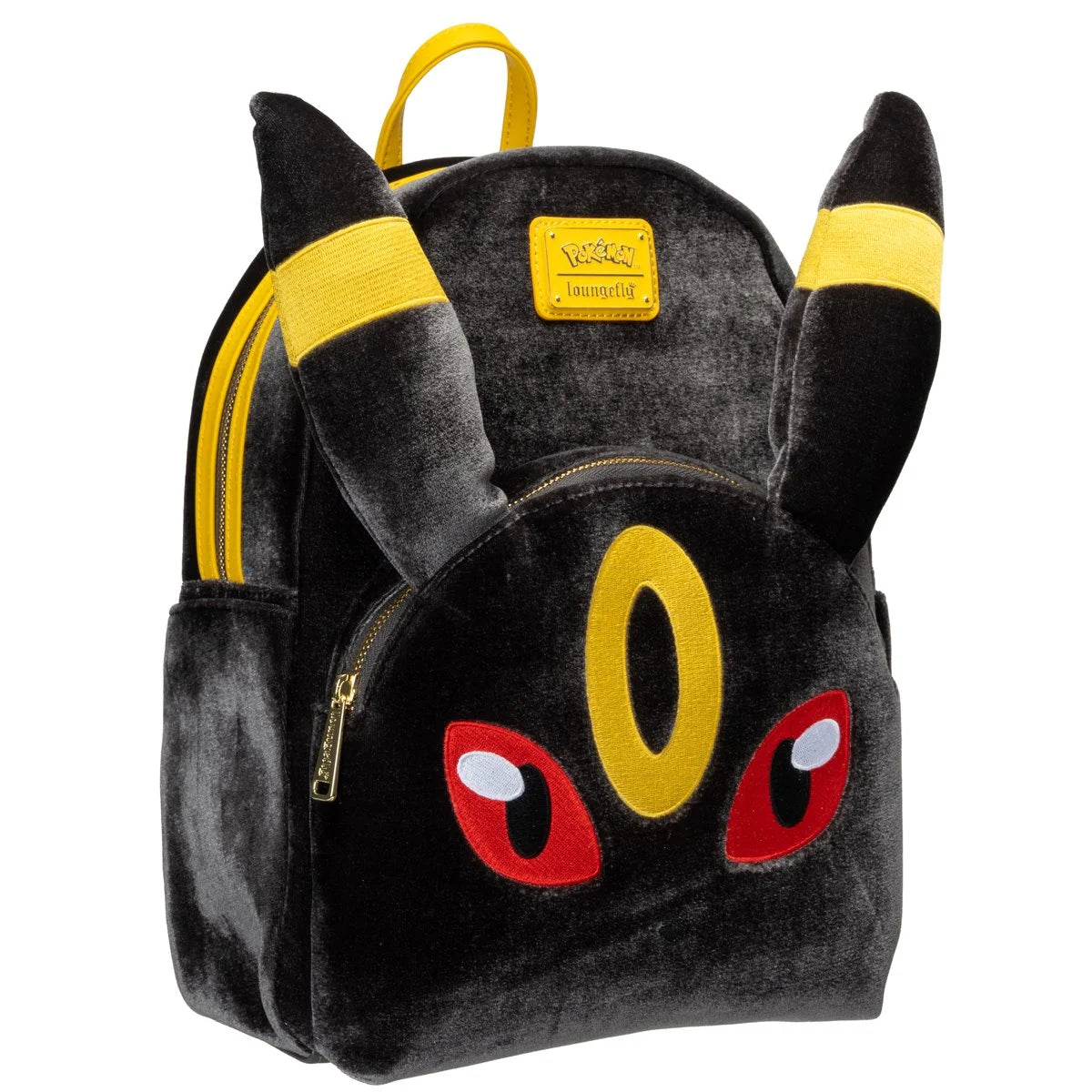 A plush black backpack designed like the Pokémon character Eevee, featuring yellow ear bands, a yellow forehead emblem, red eyes, and gold zipper pulls, shown on a plain white background.