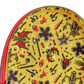 Yellow pouch with black and red tattoo-style designs on a white background