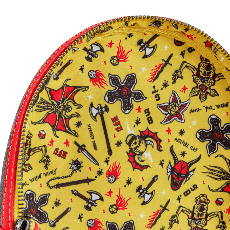 Yellow pouch with black and red tattoo-style designs on a white background
