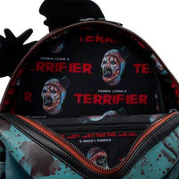 Backpack with 'Terrifier' design featuring a zombie face and blood splatter 