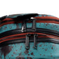 Close-up of a backpack with multiple zippers on a blue background