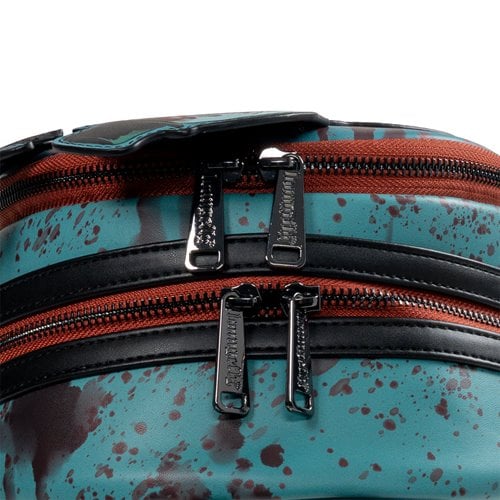 Close-up of a backpack with multiple zippers on a blue background