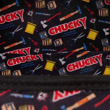Patterned fabric with 'Chucky' text and tools on a black background