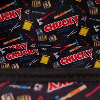 Patterned fabric with 'Chucky' text and tools on a black background