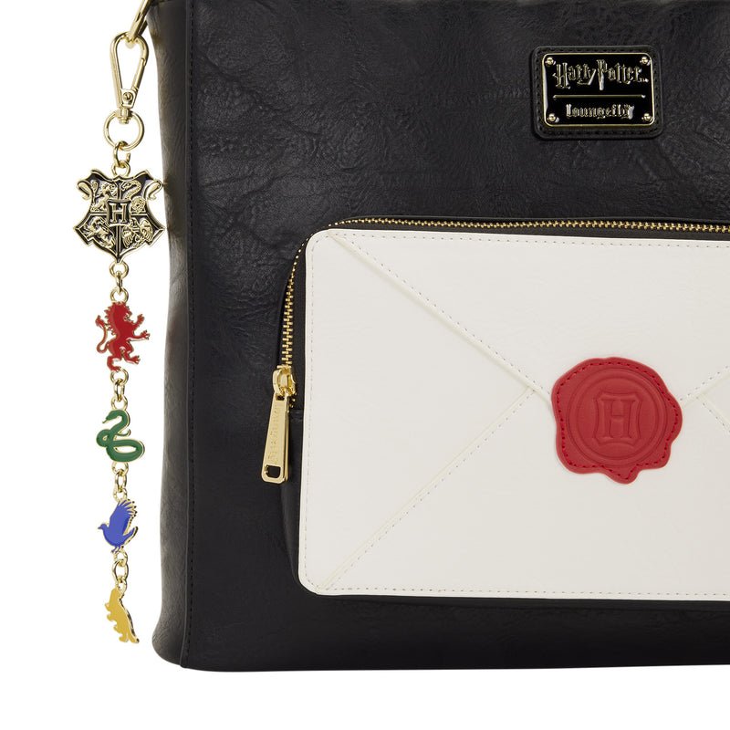 Black bag with a white pouch featuring a red 'H' emblem, Harry Potter logo, and charm.