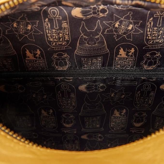 Close-up of a bag with Egyptian hieroglyphics design on a dark background.