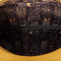 Close-up of a bag with Egyptian hieroglyphics design on a dark background.