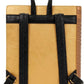 Tan leather bag with black straps on a white background
