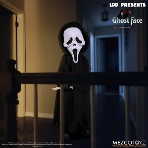 Person wearing a Ghost Face mask and black robe holding a knife in a dimly lit hallway, with Mezco Toyz branding.