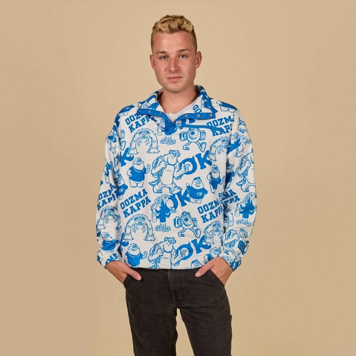 Person wearing a white hoodie with blue patterns on a beige background