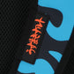 Black patch with red text on a blue and black patterned background