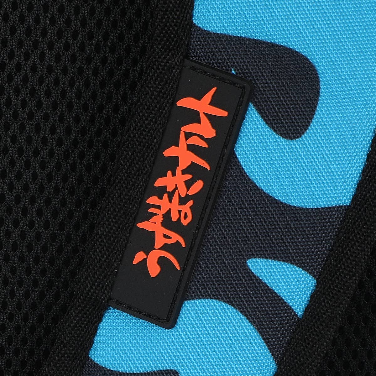 Black patch with red text on a blue and black patterned background