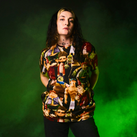 Person wearing a ParaNorman All Over Print T-Shirt with a green background