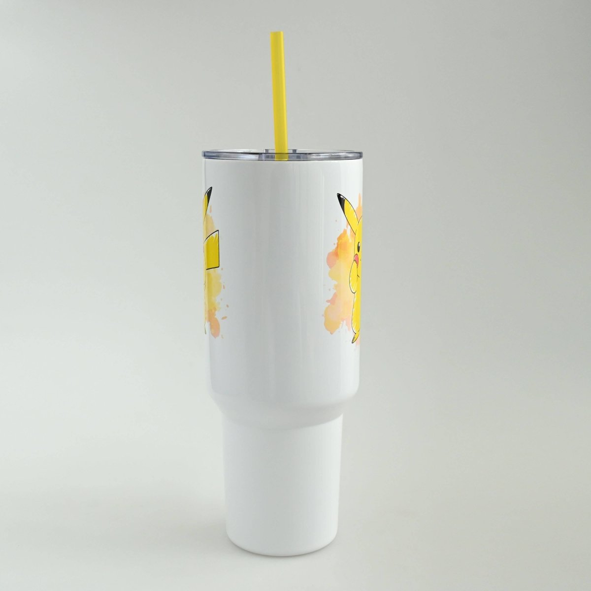 White tumbler with Pikachu design on a gray background