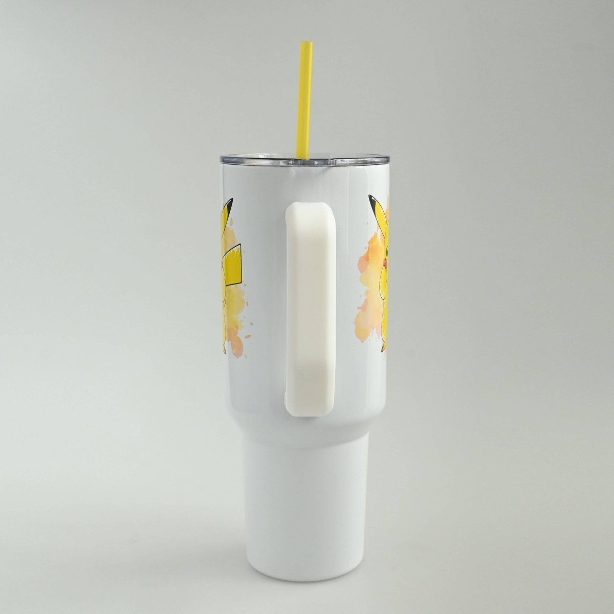 White tumbler with banana design on a gray background
