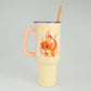 Yellow tumbler with a cartoon dragon design on a gray background