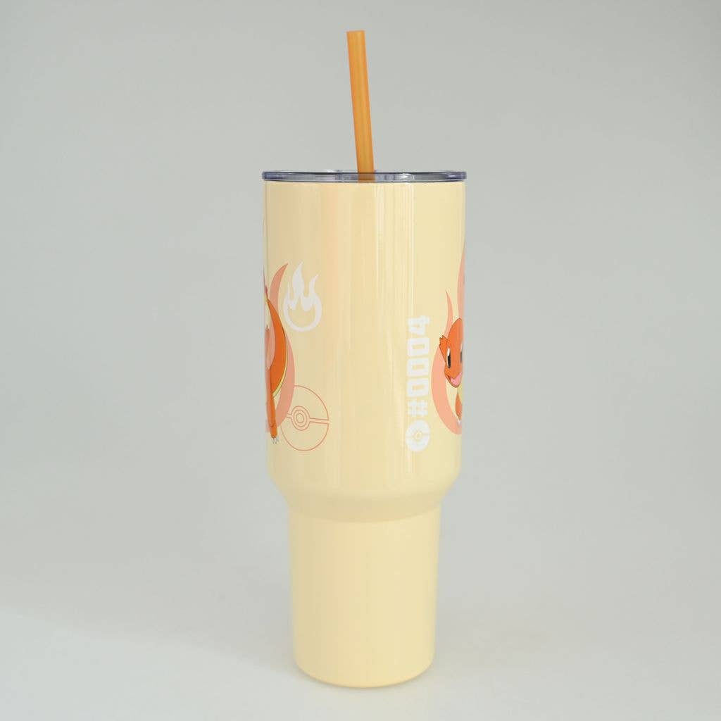 Yellow tumbler with a straw on a light gray background