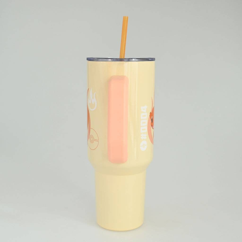Yellow tumbler with a straw on a gray background